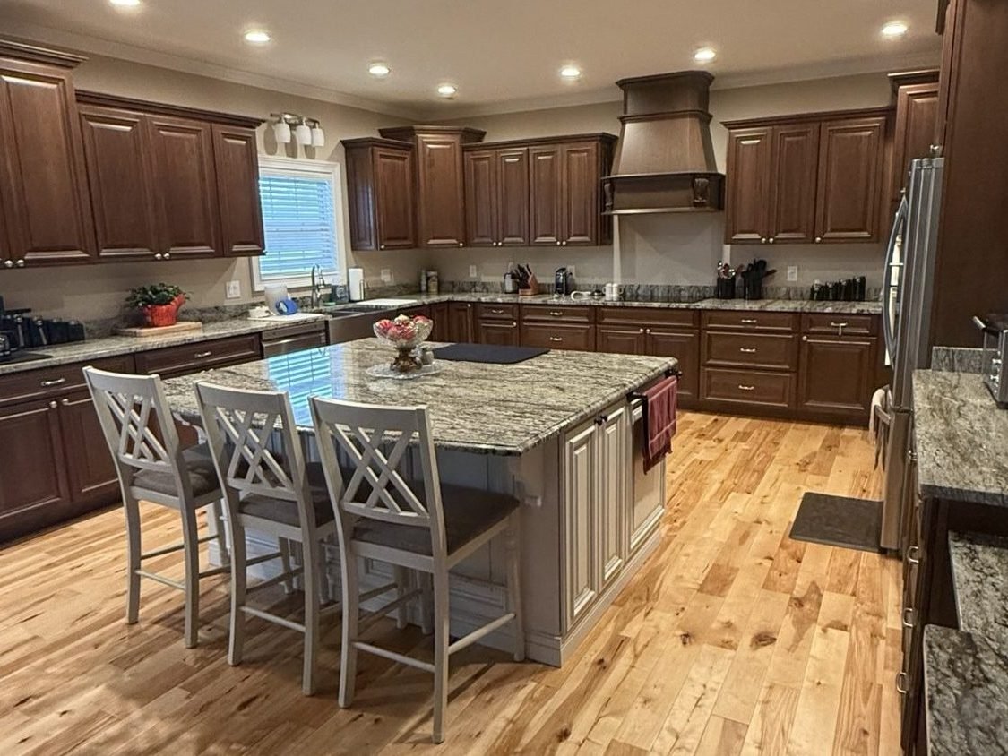 Granite countertops in a kitchen with stained cabinetry