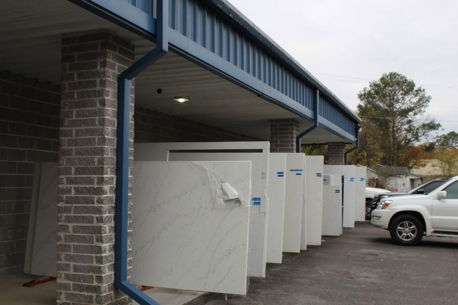 Stone slabs displayed along the covered walkway at the Value Flooring showroom